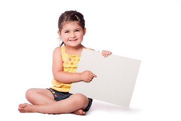 Image showing Happy girl sitting pointing at whiteboard