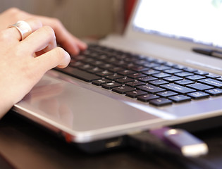 Image showing Young woman working on laptop