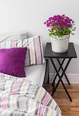 Image showing Purple flowers in a bright bedroom