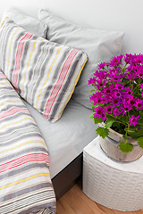 Image showing Bright purple flowers decorating a bedroom