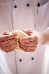 Image showing cook's arms making dough