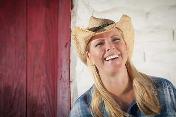 Image showing Beautiful Cowgirl Against Old Wall and Red Door