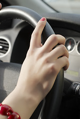 Image showing Girl hand on wheel steering