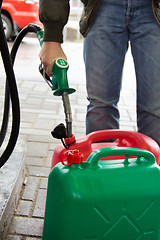 Image showing Man in jeans gas station in a plastic gasoline