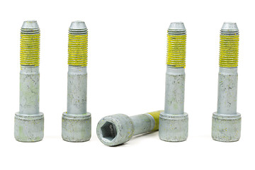 Image showing Five bolts for the car with the yellow glue on the threads.