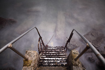 Image showing Steel and stone old ladder to sea