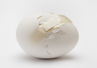 Image showing Cracked white egg with plastic plaster 
