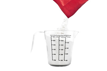 Image showing Pouring flour on Kitchen measuring cup