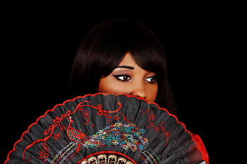 Image showing Girl behind fan.