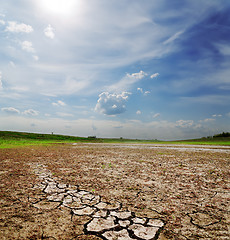 Image showing dramatic sky over dry cracked earth