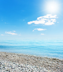 Image showing sun over beach with stones