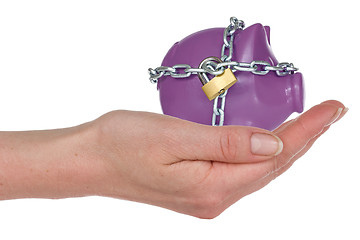 Image showing Locked piggy-bank in a hand