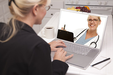 Image showing Woman In Kitchen Using Laptop - Online with Nurse or Doctor