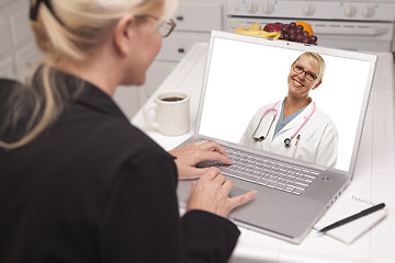 Image showing Woman In Kitchen Using Laptop - Online with Nurse or Doctor