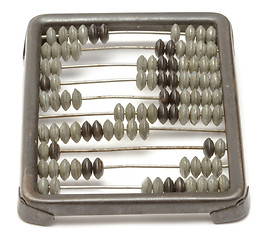 Image showing Old metallic abacus on white