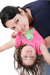 Image showing Mother playing with her daughter and holding her upside down