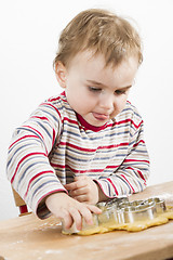 Image showing child at desk making cookies