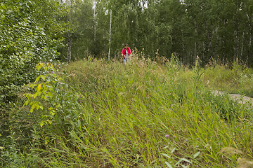 Image showing Girl rides a bike.