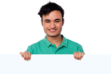 Image showing Casual young boy holding blank whiteboard