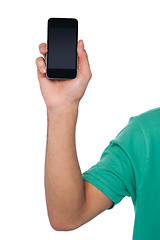 Image showing Cropped image of a guy displaying mobile handset