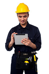 Image showing Field worker accessing touch pad