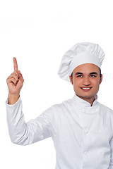 Image showing Male chef looking and pointing upwards