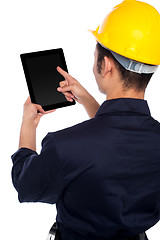 Image showing Back pose of worker operating tablet device