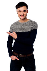 Image showing Casual young guy pointing away