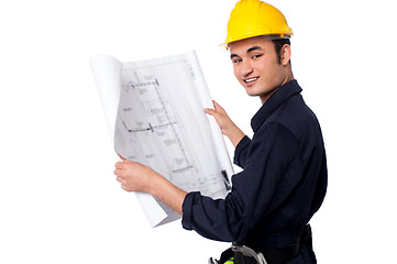 Image showing Construction worker reviewing blueprint