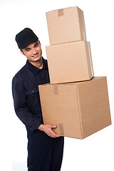 Image showing Young courier boy moving boxes