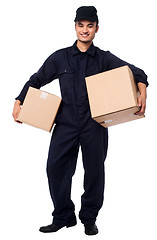 Image showing Young courier boy holding parcels