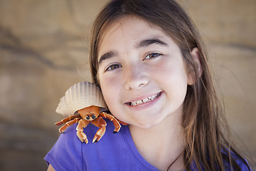 Image showing Young Girl Playing with Toy Hermit Crab