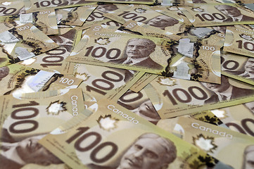 Image showing 100 Canadian dollar banknotes.