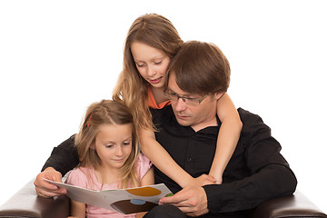 Image showing Father read a book with his daughters