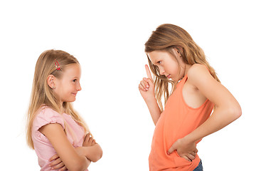 Image showing Young girl pointing finger at her sister