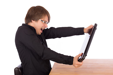 Image showing Business man tries to destroy his laptop