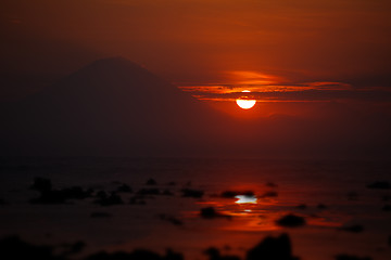 Image showing Sunset on the ocean - view of volcano Batur. Indonesia, Bali.