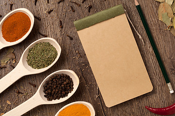 Image showing Old notebook, spices in spoons