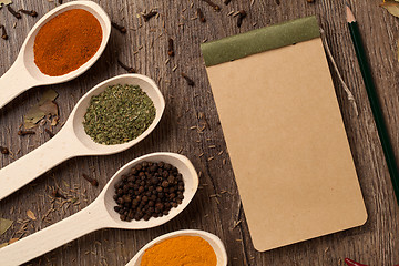 Image showing Old notebook, spices in spoons