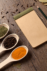 Image showing Old notebook, spices in spoons