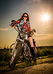 Image showing Biker girl sitting on motorcycle