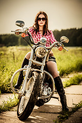 Image showing Biker girl sitting on motorcycle