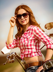 Image showing Biker girl sitting on motorcycle