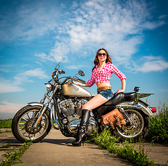 Image showing Biker girl sitting on motorcycle