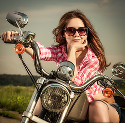 Image showing Biker girl sitting on motorcycle