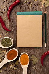 Image showing peppers, spices in spoons, notebook and pencil
