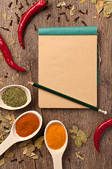 Image showing peppers, spices in spoons, notebook and pencil