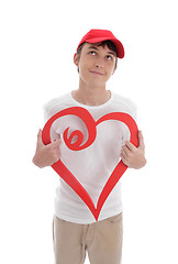 Image showing Daydreaming boy holding red love heart