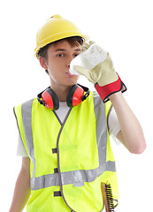 Image showing Apprentice builder drinking ice cold water