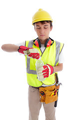 Image showing Young builder drinking a bottle of water